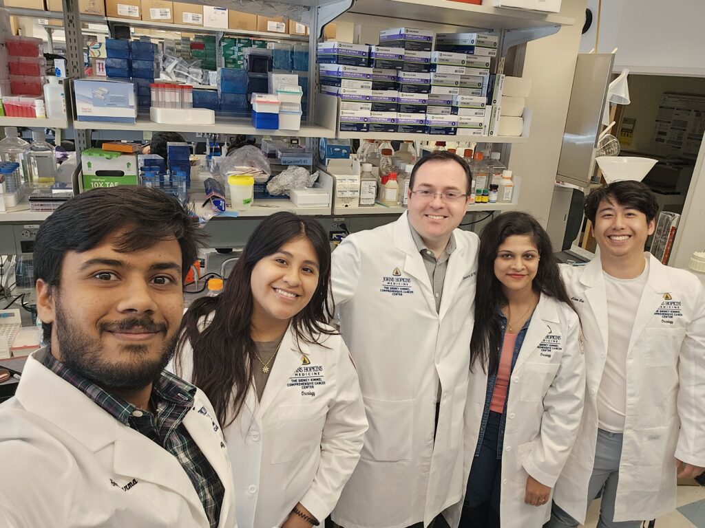 A group of people in lab coats pose for a photo